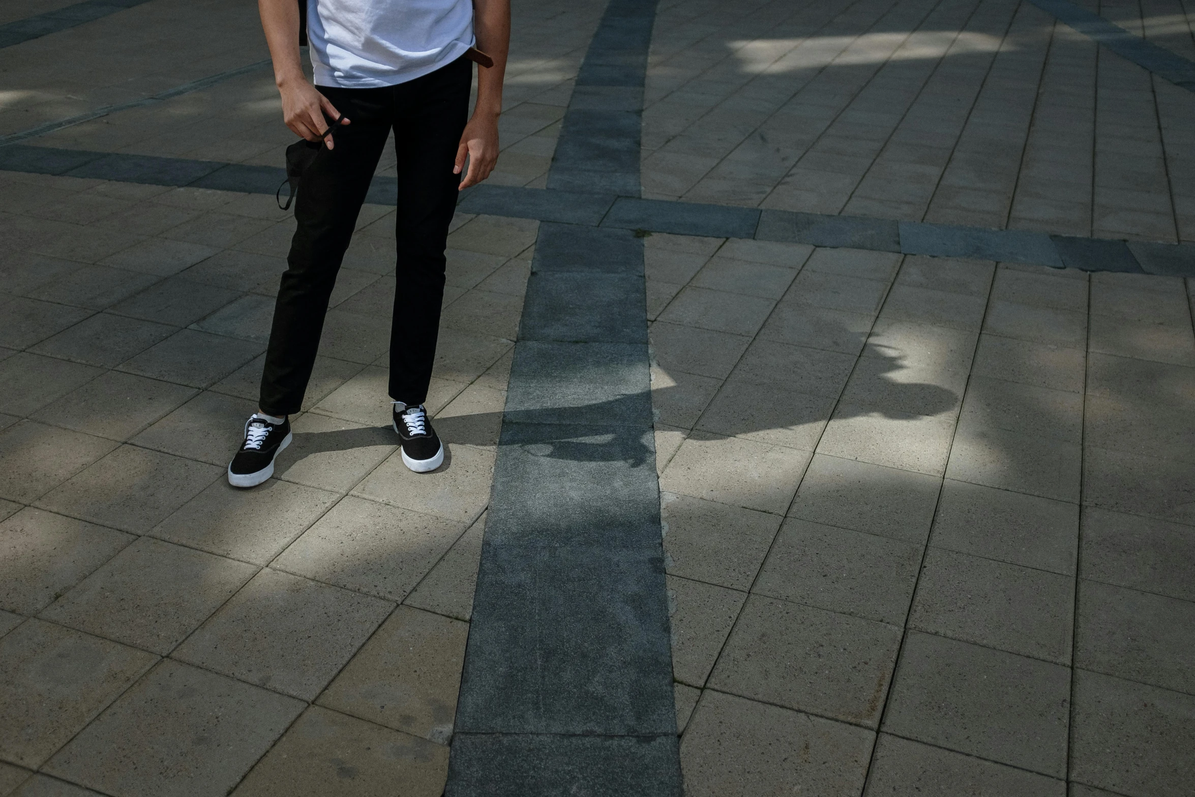 a man that is standing on a skateboard, by Attila Meszlenyi, shadow of catholic church cross, wearing white sneakers, south korean male, square lines