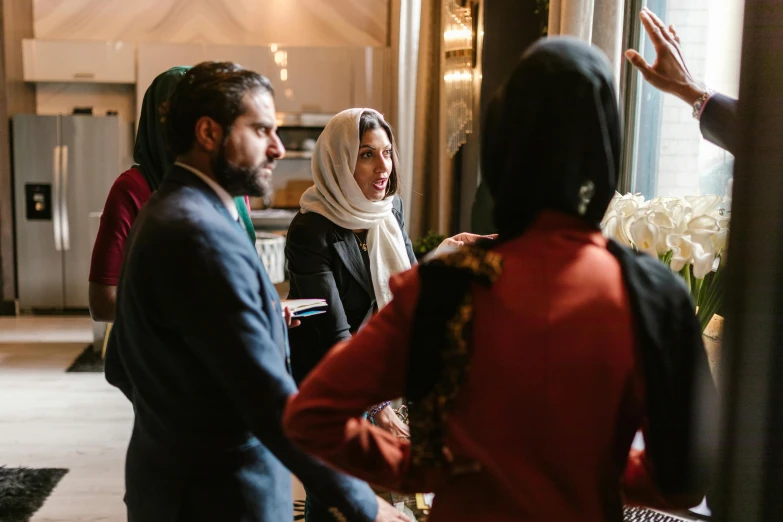 a group of people standing in a room, by Maryam Hashemi, pexels contest winner, hurufiyya, in meeting together, elegantly dressed, washington dc, profile image