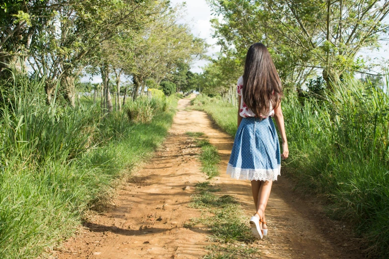 a woman is walking down a dirt road, pexels, renaissance, teen girl, são paulo, avatar image, wearing a skirt