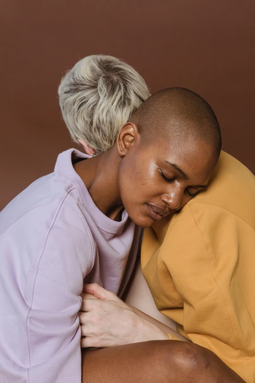 a woman with a shaved head hugging a man, trending on pexels, warm and soft and subdued colors, non-binary, her friend, ochre