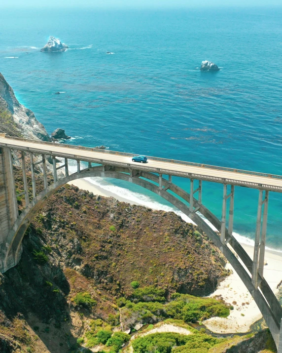 a bridge over a body of water next to a beach, pexels contest winner, renaissance, it's californication, highways, profile image, a high angle shot