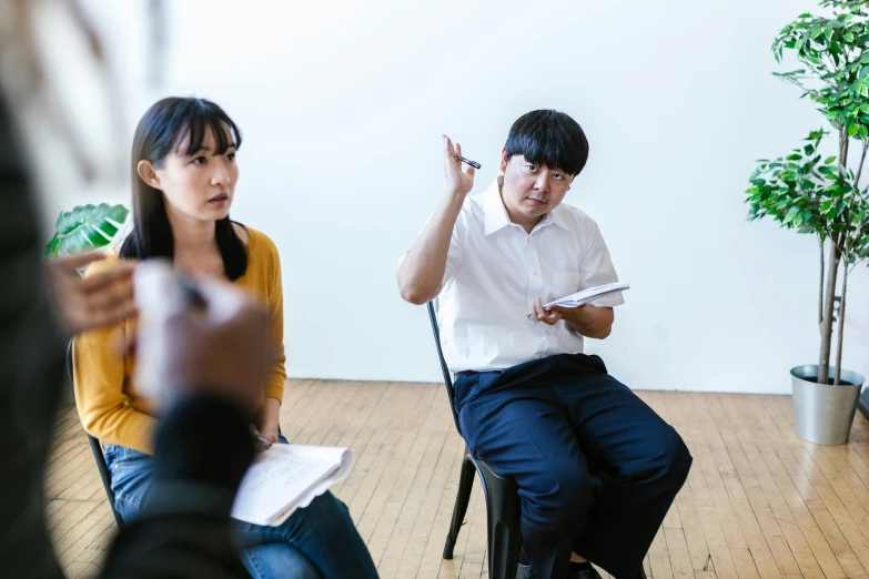 a group of people sitting in chairs in a room, by Jang Seung-eop, unsplash, ashcan school, medium shot of two characters, teaching, ignant, narumi kakinouchi