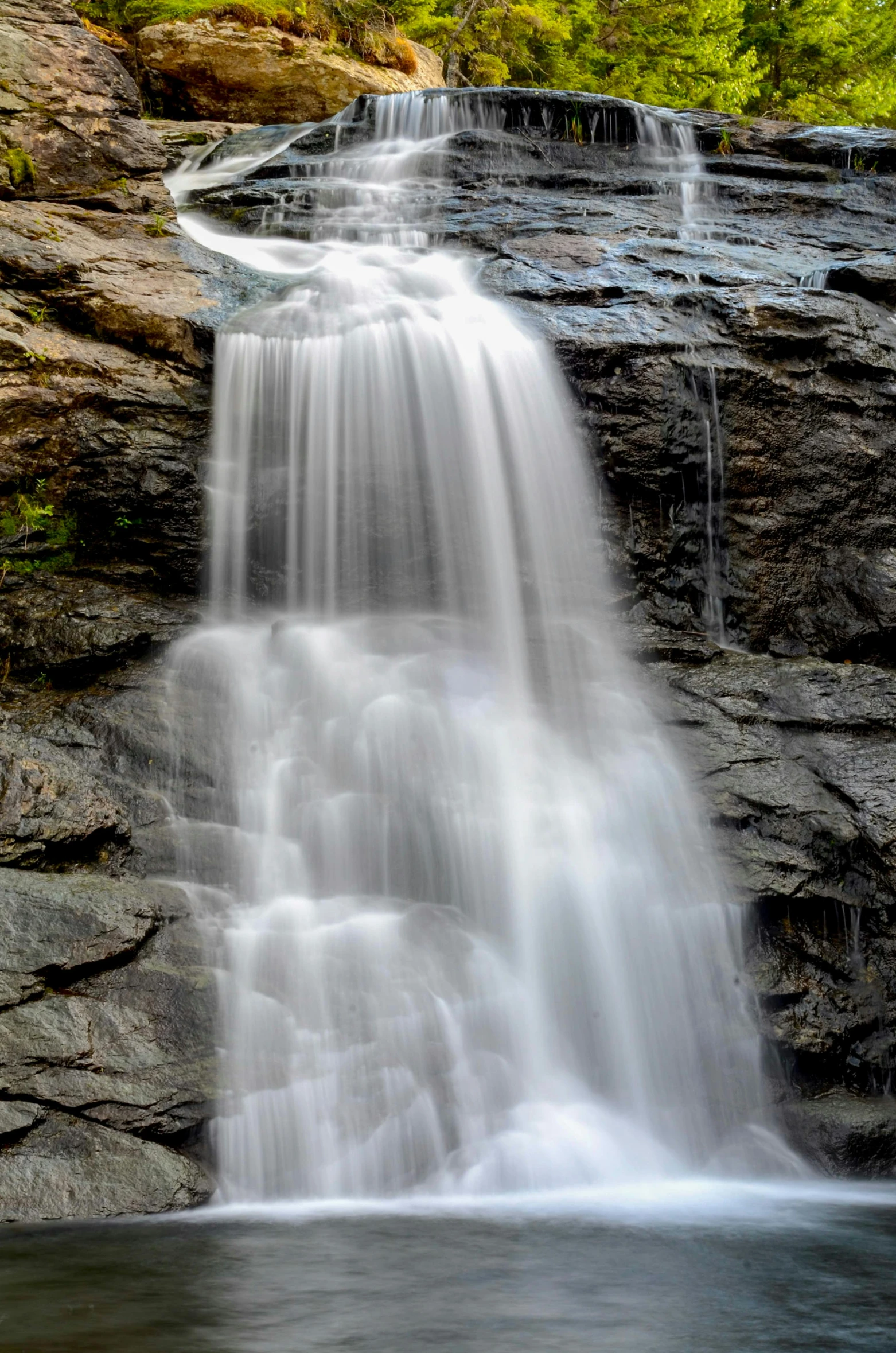 a waterfall in the middle of a forest, new hampshire, close up image, trending photo, 3/4 front view