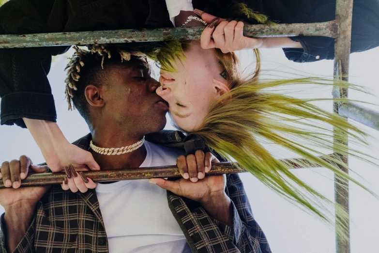 a man giving a woman a kiss on the cheek, by Ellen Gallagher, trending on pexels, renaissance, black teenage boy, portrait of kim petras, shot from below, green and brown clothes