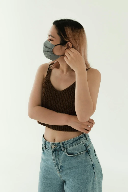 a woman wearing a face mask while talking on a cell phone, by Simon Gaon, trending on pexels, renaissance, wearing a sexy cropped top, square nose, korean women's fashion model, avatar image