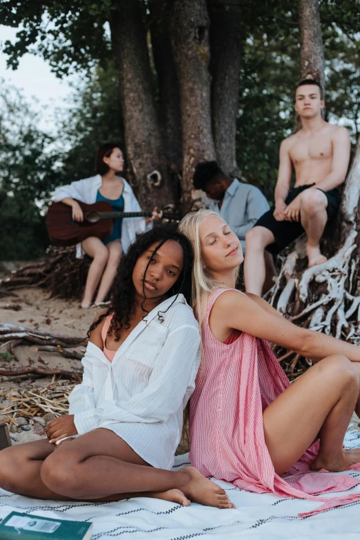 a group of people sitting next to each other on a beach, an album cover, unsplash, renaissance, with a white complexion, sitting on a tree, blonde women, sydney park