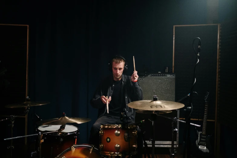 a man playing drums in a dark room, a portrait, inspired by Seb McKinnon, pexels contest winner, plain background, 15081959 21121991 01012000 4k, annoyed, portrait of small