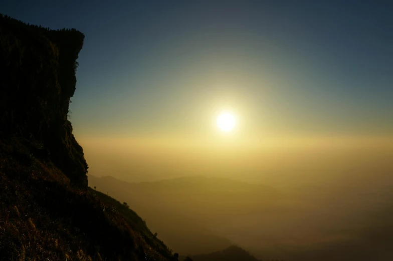 a person standing on top of a mountain at sunset, by Peter Churcher, pexels contest winner, romanticism, coban, yellow, laos, slide show