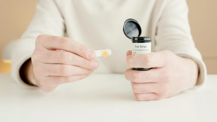 a close up of a person holding a toothbrush, inspired by Larry Zox, taking tobacco snuff, top lid, opening shot, with a white background