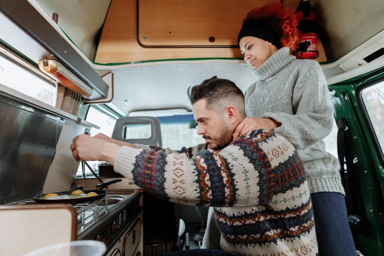 a man and woman cooking in a camper van, pexels contest winner, winter, avatar image, maintenance, handsome