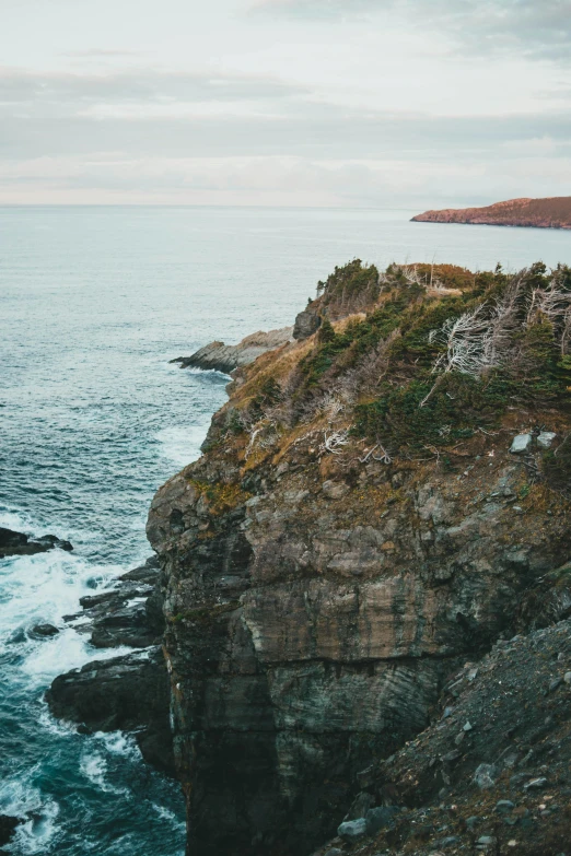 a man standing on top of a cliff next to the ocean, muted fall colors, hestiasula head, slide show, canvas