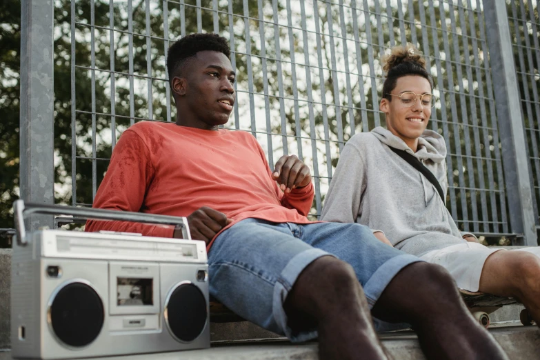 a man and a woman sitting next to each other, trending on pexels, boombox, black teenage boy, 15081959 21121991 01012000 4k, thumbnail