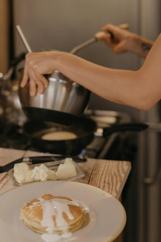 a close up of a plate of food on a counter, a picture, pouring, ignant, pan and plates, eating cheese