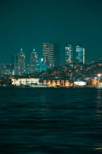 a large body of water with a city in the background, inspired by Elsa Bleda, pexels contest winner, turkey, night life buildings, viewed from the ocean, slide show
