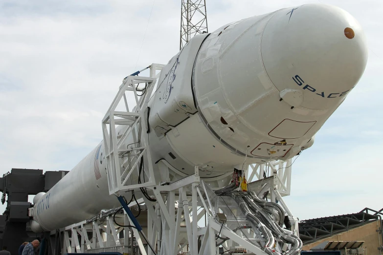 a large white rocket sitting on top of a runway, happening, spacex, in 2 0 1 5, close - up photo, vine