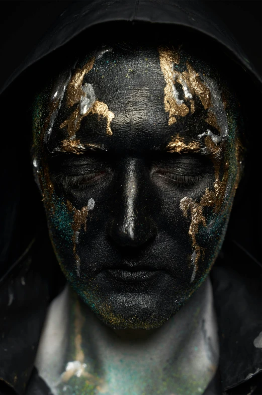 a man with black and gold paint on his face, an album cover, inspired by Nicola Samori, trending on zbrush central, painted marble sculptures, paul barson, trent reznor, still from a music video