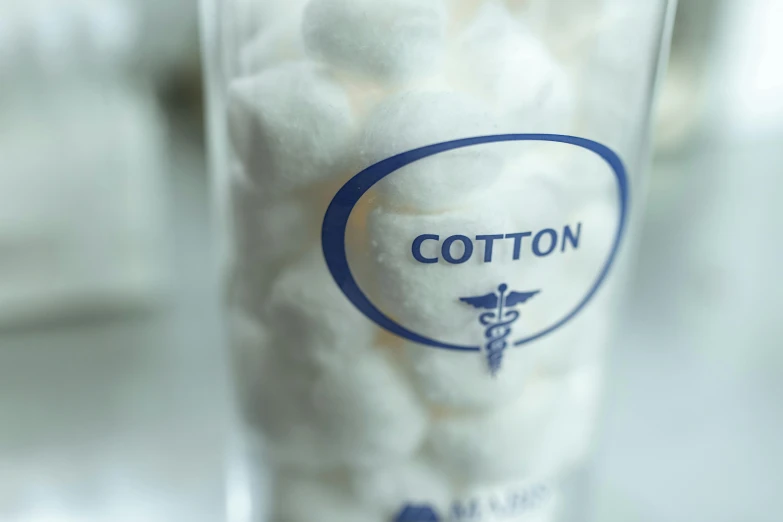 a glass filled with cotton balls sitting on top of a table, private press, medical labels, conor walton, medium close up, product shot