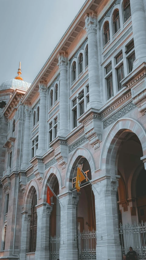 a large building with a clock on the front of it, pexels contest winner, art nouveau, gray and orange colours, archways, thumbnail, istanbul