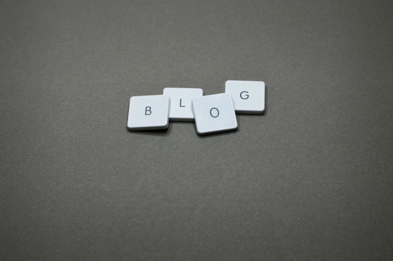 a couple of dice pieces sitting on top of a table, favicon, blog-photo, grey, square