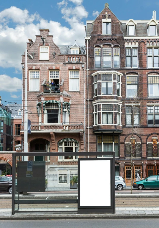 a bus stop on a city street next to a tall building, de stijl, view of houses in amsterdam, billboard image, no - text no - logo, victorian architecture