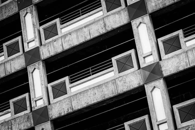 a black and white photo of a building, unsplash, brutalism, crenellated balconies, vibrant contrast, high details photo