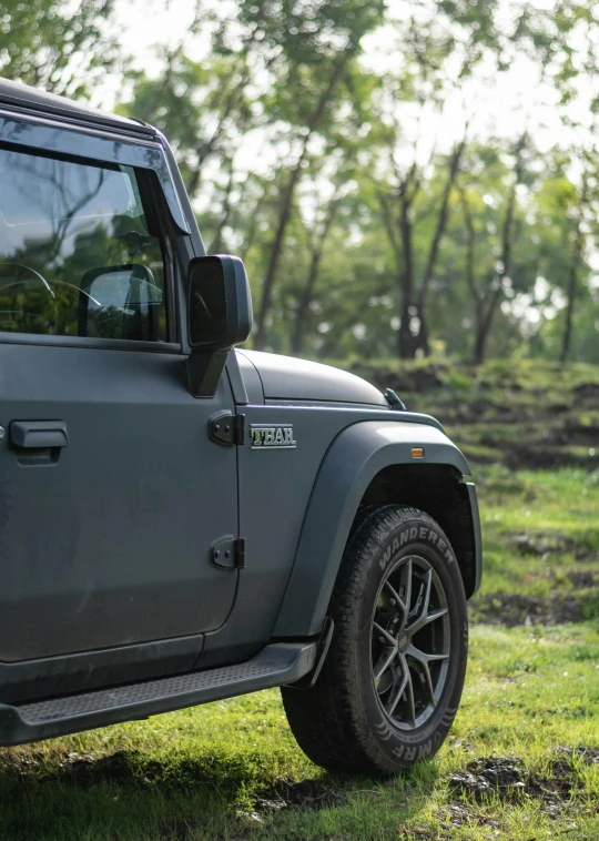 a black jeep parked on top of a lush green field, profile image, mahindra thar, [ cinematic, square