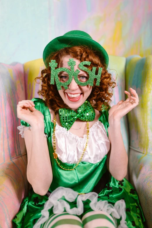 a woman in a green costume sitting in a chair, inspired by Ron English, pexels, kitsch movement, irish, a still of a happy, 2 5 6 x 2 5 6 pixels, and