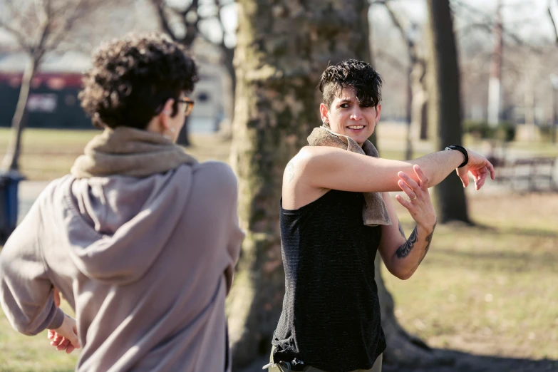 a man and a woman playing frisbee in a park, by Nina Hamnett, pexels contest winner, renaissance, lesbian embrace, shrugging arms, close-up photograph, behind the scenes