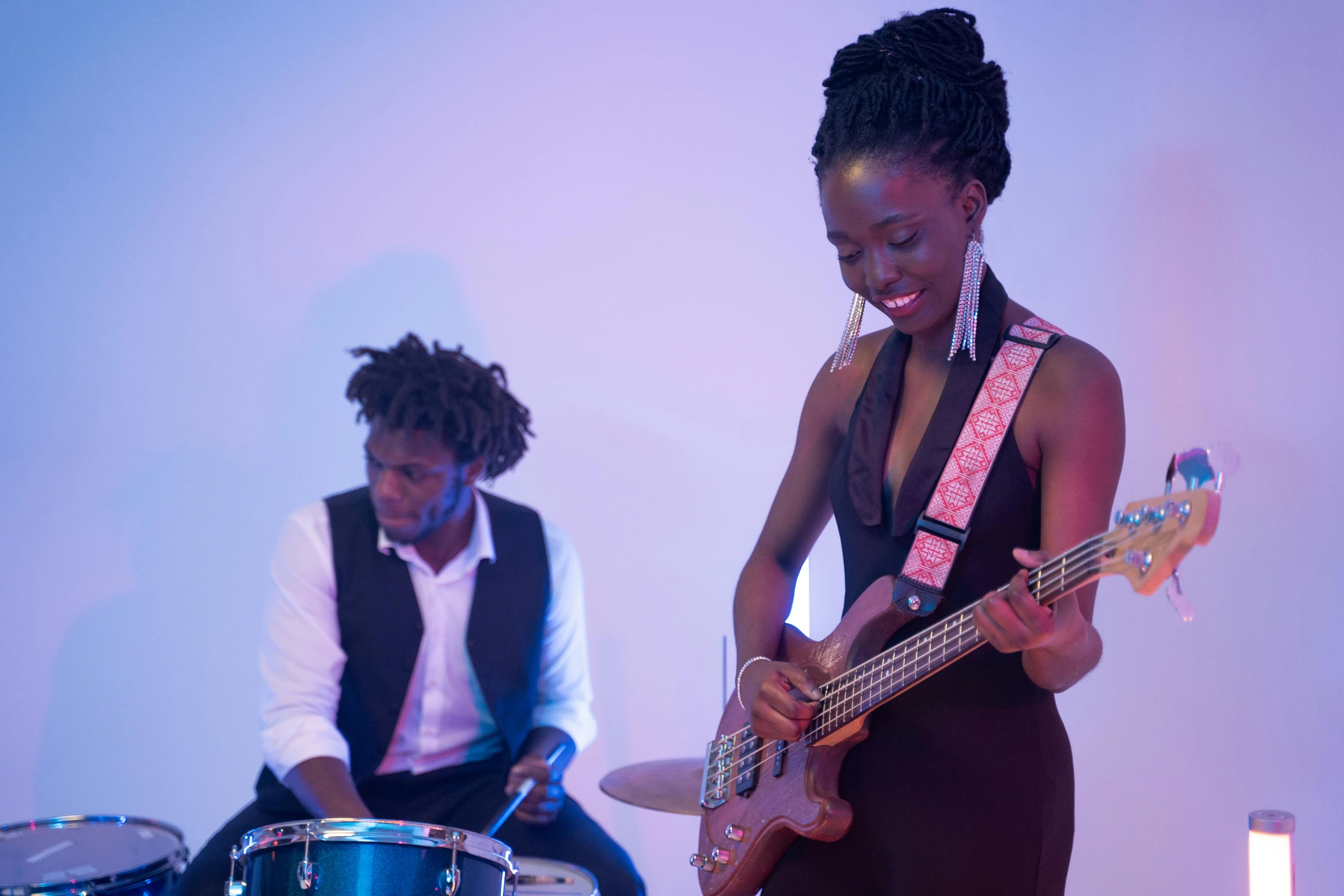 a woman standing next to a man holding a guitar, pexels contest winner, black arts movement, playing drums, emmanuel shiru, 15081959 21121991 01012000 4k, strathmore 2 0 0