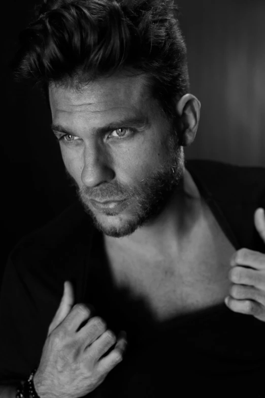 a black and white photo of a man with a beard, by Giorgio Cavallon, photorealism, mid-shot of a hunky, sultry expression, square, david beckham