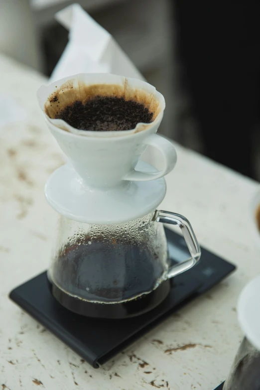 a close up of a coffee pot on a table, thumbnail, jakarta, peaks, average