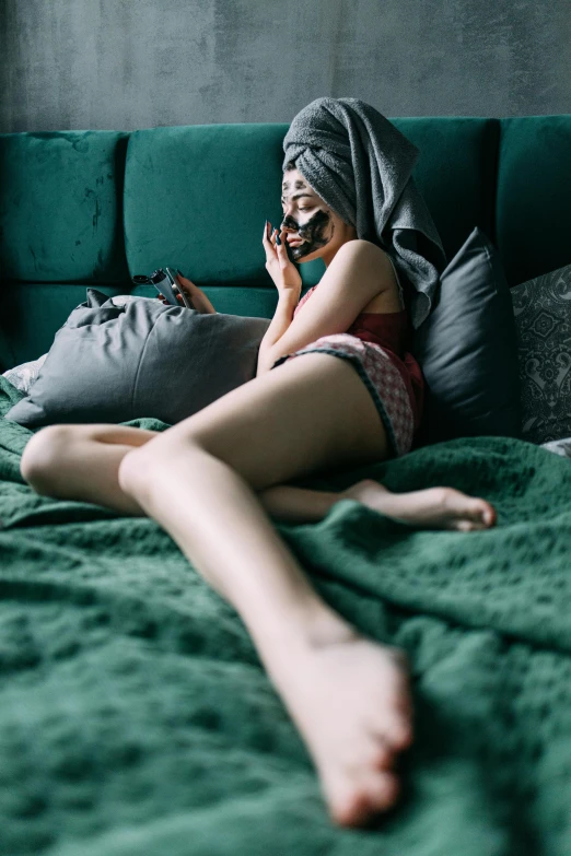 a woman laying on a bed talking on a cell phone, inspired by Elsa Bleda, trending on pexels, renaissance, large thighs, with a covered face, 2263539546], single