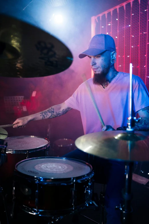 a man that is sitting in front of a drum, an album cover, inspired by Seb McKinnon, pexels contest winner, sam hyde, lights, profile image, performing