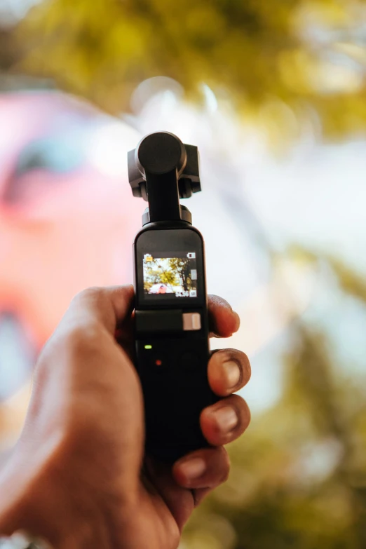 a person holding a cell phone in their hand, taken on go pro hero8, holding a torch, blurry footage, movie filmstill