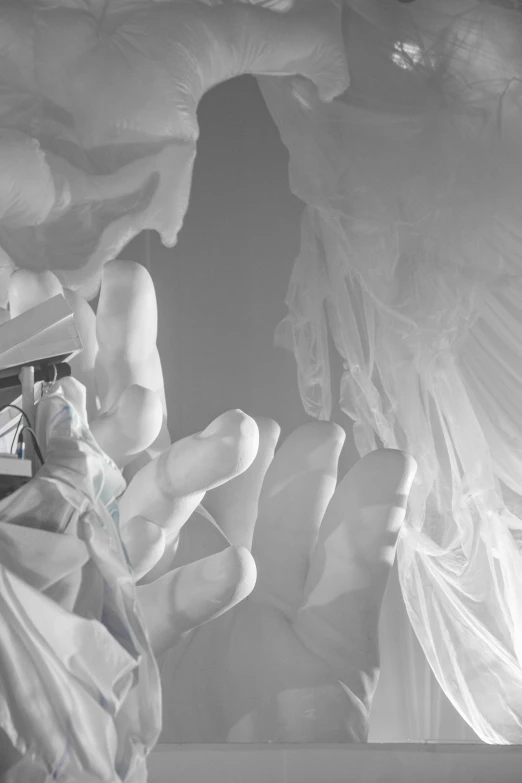 a black and white photo of a statue of an angel, an ambient occlusion render, inspired by Gian Lorenzo Bernini, covered in transparent cloth, closeup of arms, holding an epée, opal statues