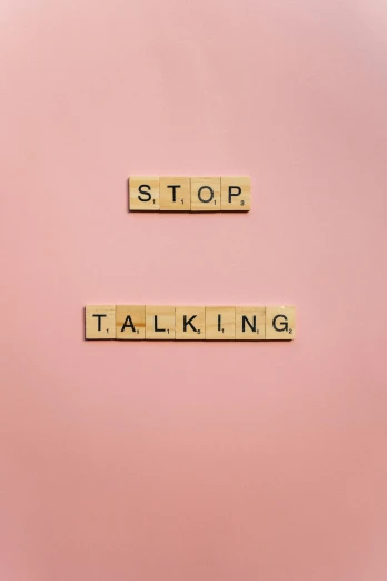 scrabbles spelling stop talking on a pink background, an album cover, by Claire Falkenstein, shutterstock, happening, 256x256, taken on iphone 1 3 pro, biological, tan