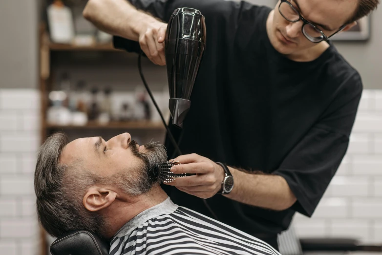 a man getting a haircut at a barber shop, pexels contest winner, thick neck, lachlan bailey, thumbnail, bearded and built