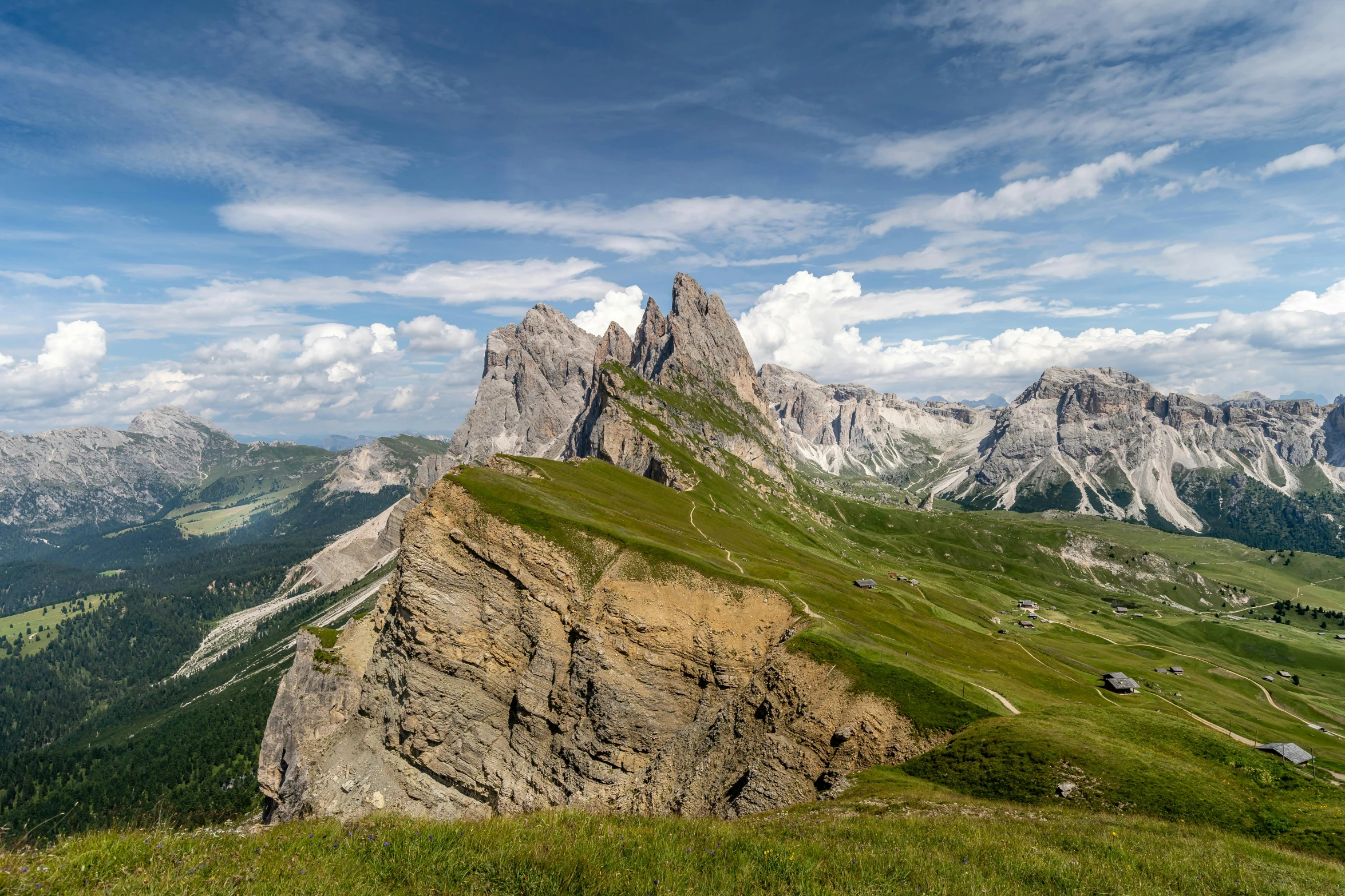 a group of people standing on top of a mountain, by Carlo Martini, pexels contest winner, renaissance, asymmetrical spires, mountain behind meadow, view from above, geological strata