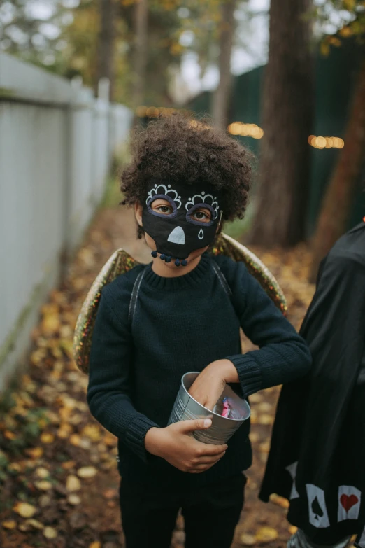 a couple of kids standing next to each other, pexels contest winner, trick or treat, black mask, winged boy, dark grey