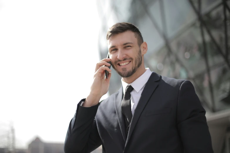 a man in a suit talking on a cell phone, pexels contest winner, smiling :: attractive, avatar image, maintenance, multiple stories