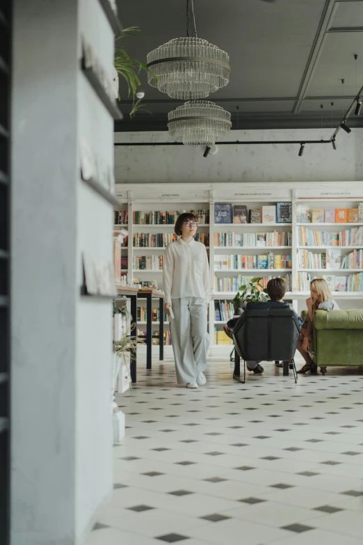 a couple of people that are standing in a room, in a library, in a white boho style studio, ekaterina, open plan