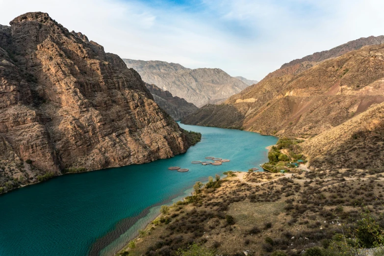 a large body of water surrounded by mountains, by Daren Bader, pexels contest winner, hurufiyya, mesopotamic, turquoise water, conde nast traveler photo, river and trees and hills