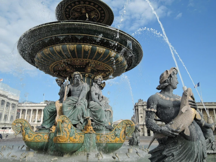 a group of statues sitting on top of a fountain, ornate french architecture, square, fan favorite, afp