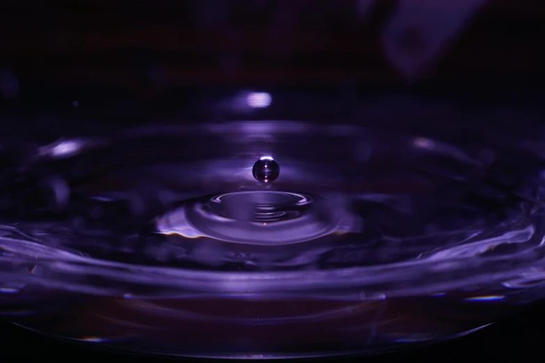 a close up of a water drop in a bowl, by Sebastian Vrancx, pexels, holography, purple tubes, orrery, dof:-1, 4 k close up