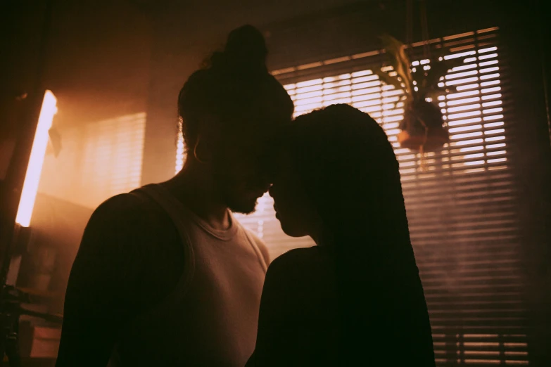 a couple standing next to each other in front of a window, inspired by Elsa Bleda, pexels contest winner, reylo kissing, dimly lit room, jen bartel, backlight glow