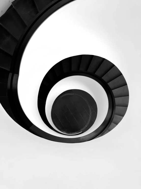 a black and white photo of a spiral staircase, a black and white photo, by Ugo Nespolo, minimalism, trending on society6, ilustration, style of maciej kuciara, 2022 photograph