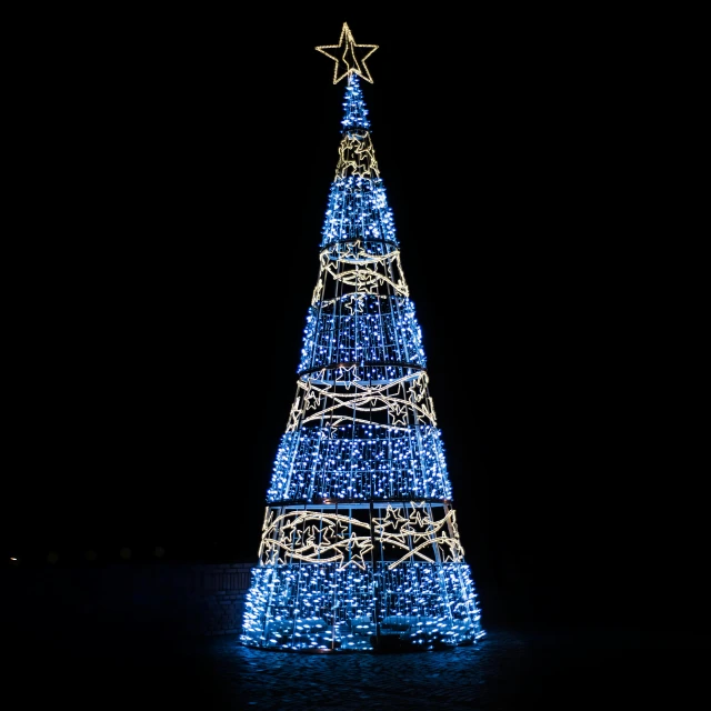 a large christmas tree is lit up at night, by Adam Marczyński, visual art, light mode, square, blue shiny lighting, cone