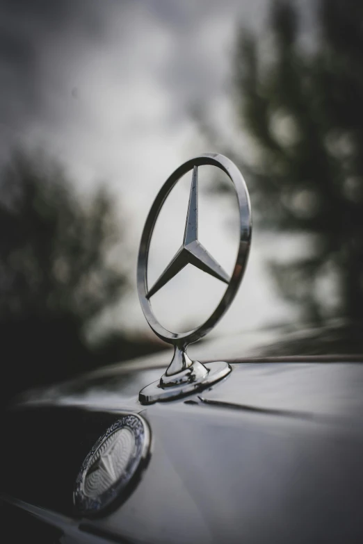 a mercedes emblem on the hood of a car, by Adam Rex, trending on pexels, low angle photo, profile picture, vintage photo, instagram story