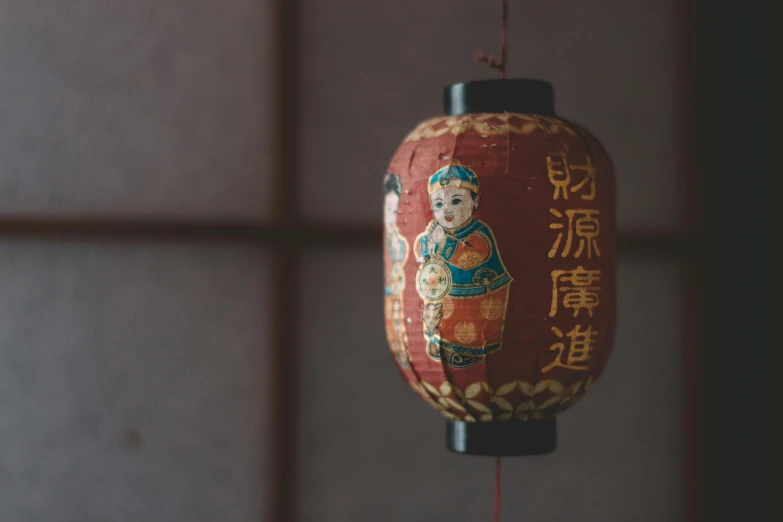 a chinese paper lantern hanging from a ceiling, a picture, inspired by Tani Bunchō, pexels contest winner, tiny statue on display, acupuncture treatment, brown, looking straight forward