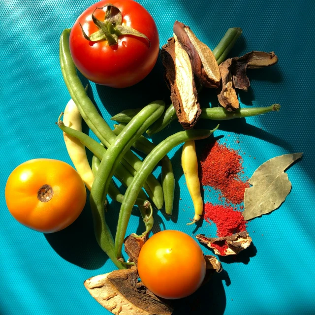 tomatoes, green beans, and other vegetables on a blue surface, by Mardi Barrie, unsplash, renaissance, ocher and turquoise colors, 15081959 21121991 01012000 4k, spices, portait image